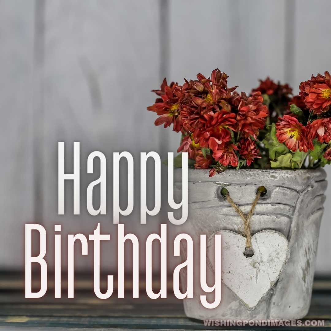 Small beautiful pot with a heart and flowers on wooden background - Happy Birthday Flower Images